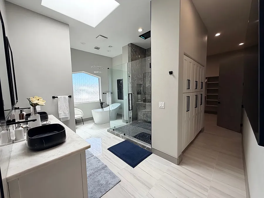Bathroom at the house with a freestanding tub by the window and a walk-in shower